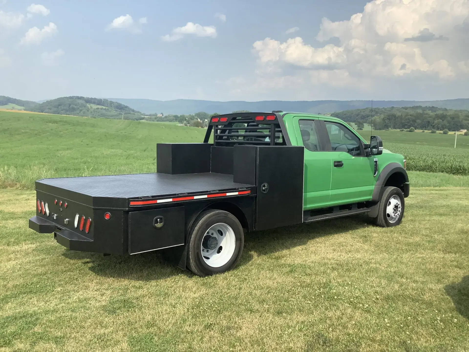 Apple green pickup truck with a black trailer attachment at the back
