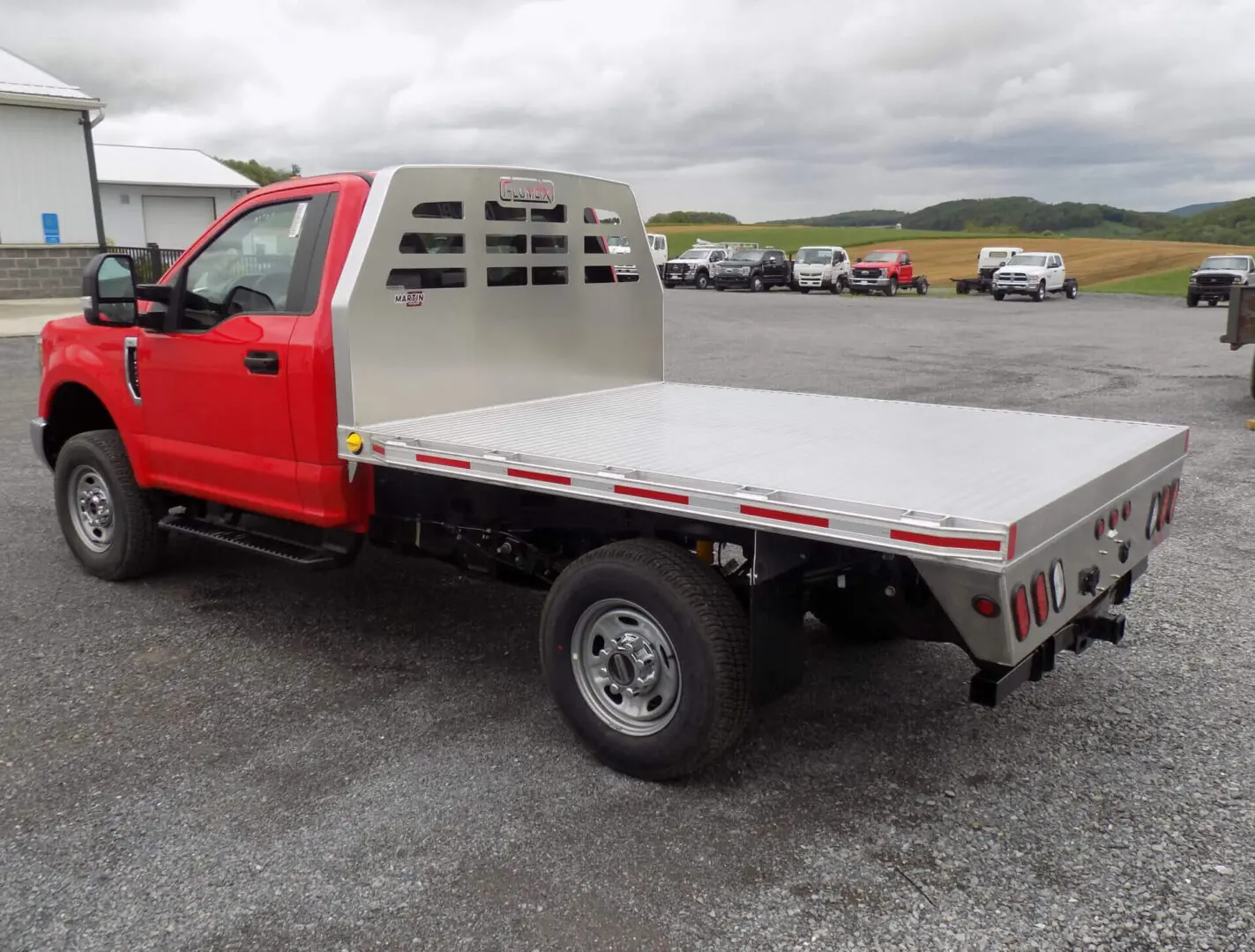 Red pickup truck with a white trailer attachment at the back